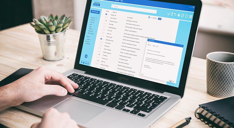 Email message communication. Man working with a computer, client mail list on laptop screen, office desk background.